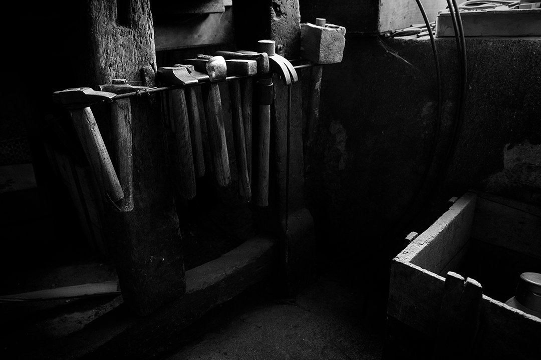 Metal components and containers in a dark interior.